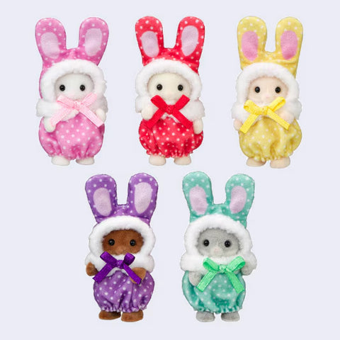 Five Calico Critters baby figures wearing colorful bunny costumes in pink, red, yellow, purple, and mint green, each with long bunny ears and a matching ribbon bow.