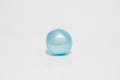 Single translucent light blue oil squishy ball with a glossy surface, photographed against a white background.