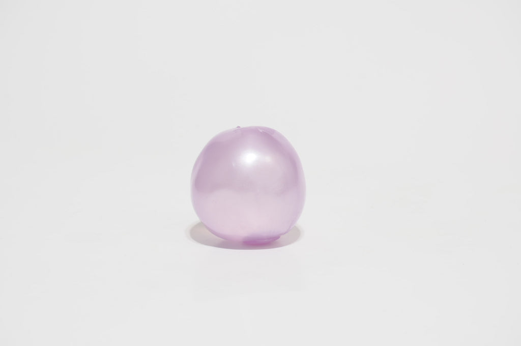  Single translucent lavender purple oil squishy ball with a smooth, glossy surface, displayed against a white background.