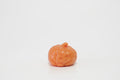 Orange pumpkin-shaped crunchy squishy with an angry jack-o'-lantern face, triangular nose, jagged grin, molded pumpkin ridges, and a short stem on top, against a white background.